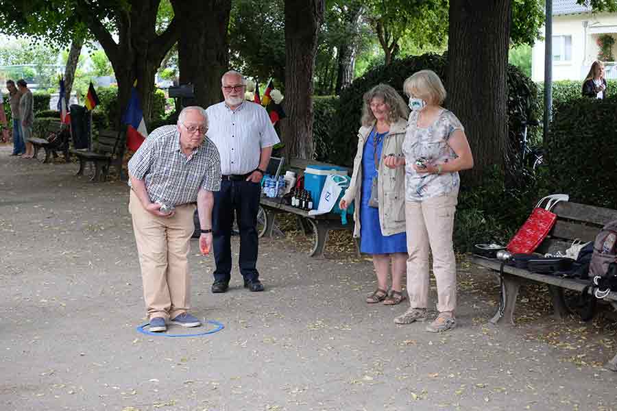 Bild: Rolf Beitzel konzentriert sich auf den Wurf des „Schweinchens“, während Vorsitzender Karl Schmitz, Christa Bückmann und Anne Beitzel das Geschehen beobachten.